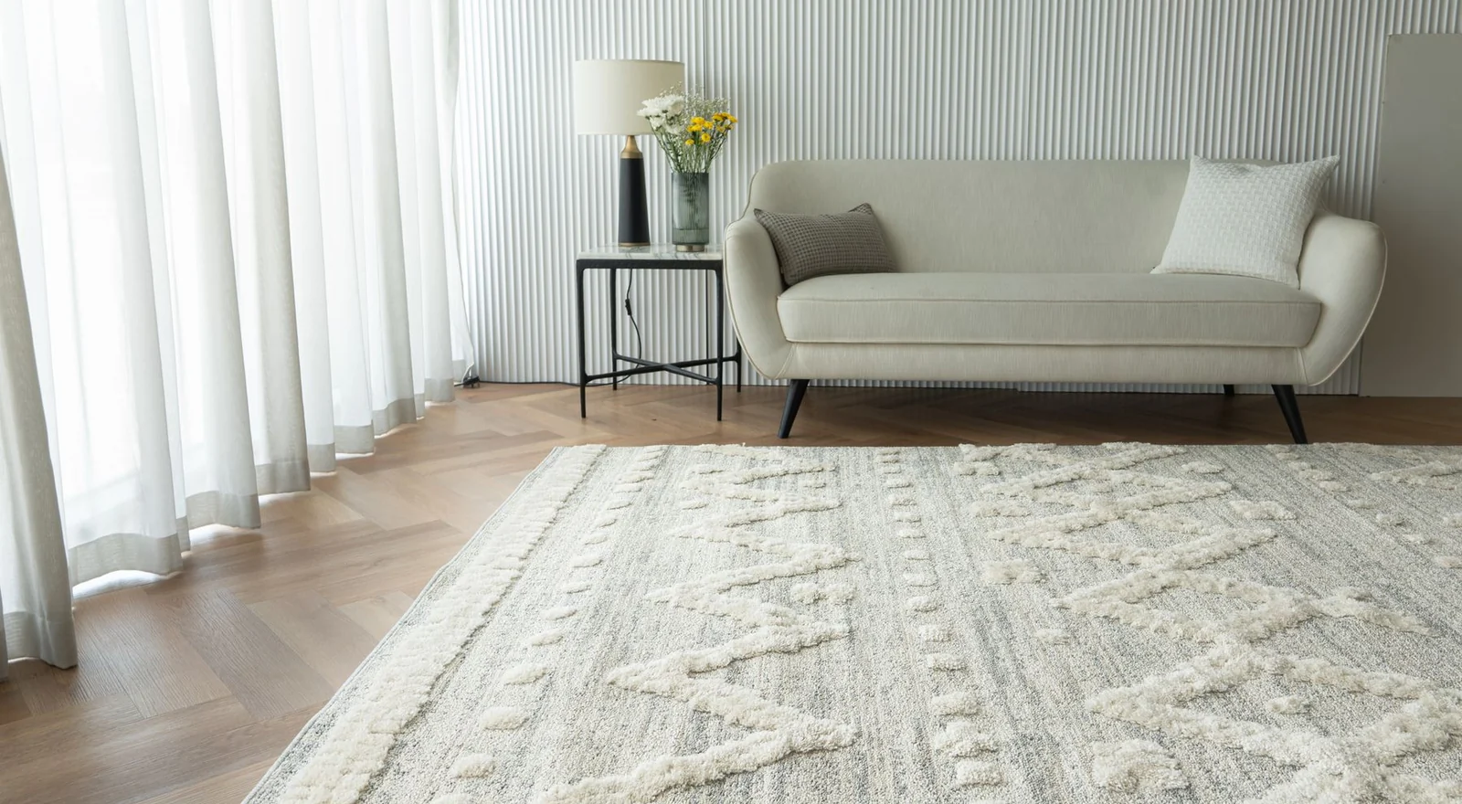 A quiet contemporary living room with natural wood and soft upholstery